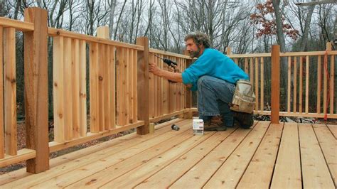 a man working on a wooden deck in the woods