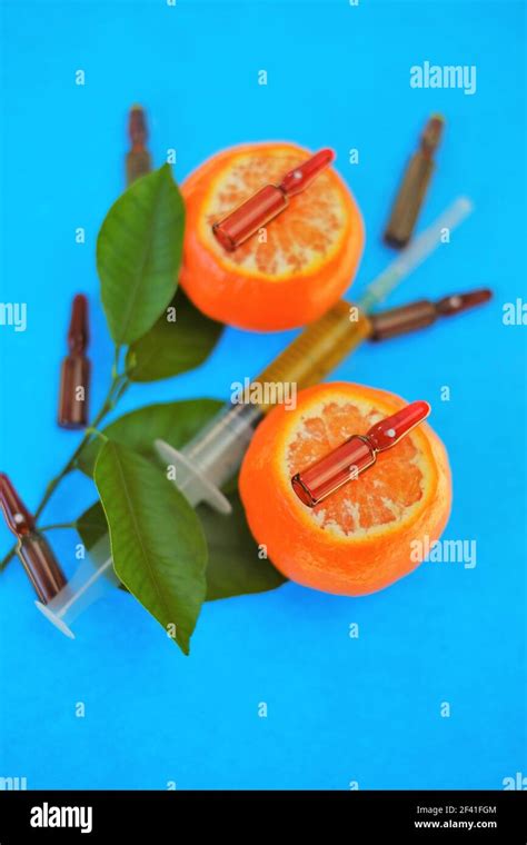 Vitamin C. Serum with Vitamin C. Glass ampoules close-up and syringe with injection solution on ...