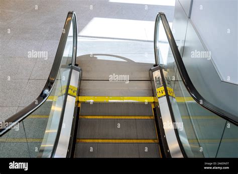 Escalator at clean escalator closeup at the international airport terminal Stock Photo - Alamy