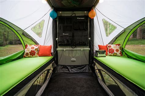 the inside of a camper with two twin beds and pillows on it's sides