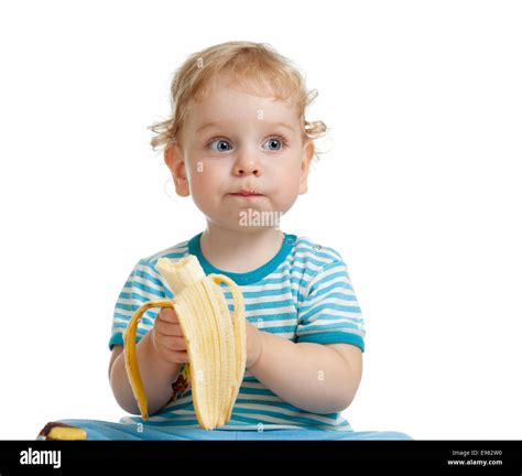 Kid boy eating banana isolated Stock Photo - Alamy