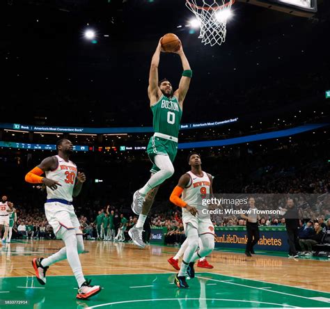 Jayson Tatum of the Boston Celtics goes in for a dunk as Julius... News ...