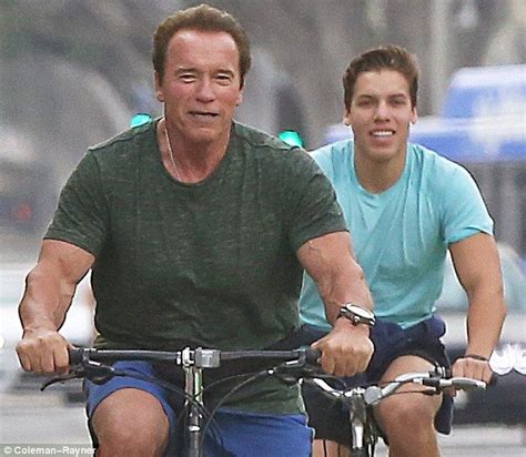 Arnold Schwarzenegger cycles with look-alike lovechild Joseph Baena ...