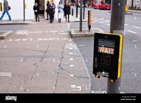 Pedestrians waiting to cross the road at a pelican crossing, UK Stock ...