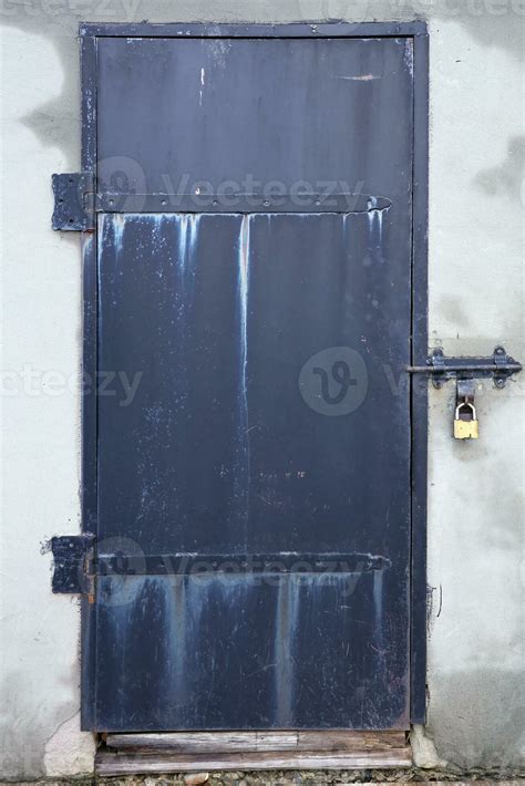 Black old metal door texture with iron handle and concrete wall ...