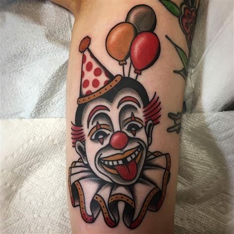 a clown with balloons on his head is shown in this tattoo design by the artist