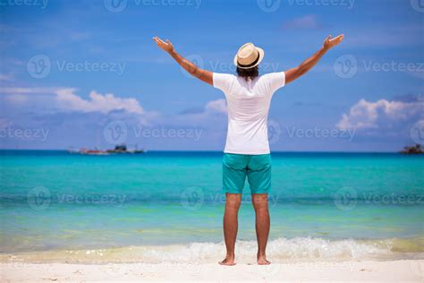 Happy young man in casual white top white beach background 17755702 Stock Photo at Vecteezy