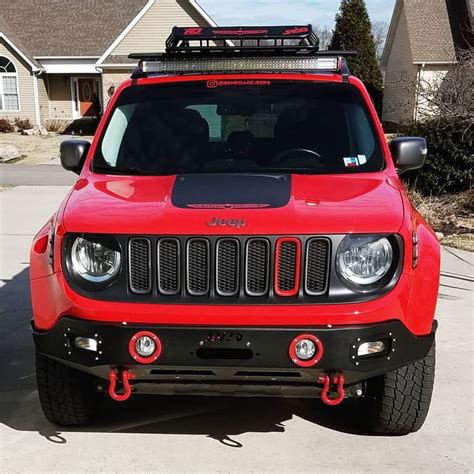 a red jeep parked in front of a house