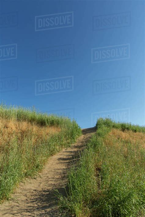 Dirt path on hill - Stock Photo - Dissolve