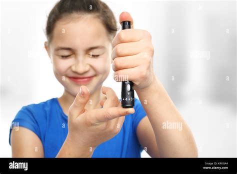 diabetic girl measuring sugar level with a glucometer Stock Photo - Alamy