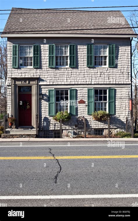 exterior gray shingle Federal style house dating from 1820 with green shutters & lace curtains ...