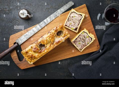 Traditional French Pate en croute with goose meat and liver as top view on a modern design ...