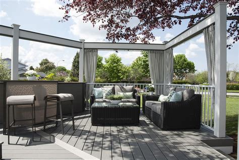 Crisp white accents, silvery decking, and retractable privacy curtains make this deck into a ...