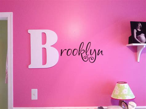Great way to display baby's name in the nursery. Wooden first letter and vinyl wall art for ...