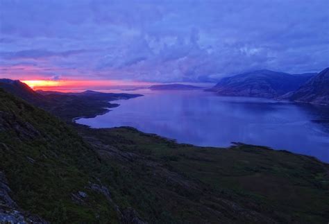 The midnight sun pops down below the clouds for a moment in Northern Norway in early July ...