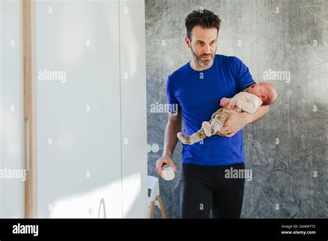 Father carrying baby Stock Photo - Alamy