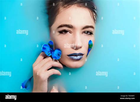 brunette girl with flowers in blue water Stock Photo - Alamy