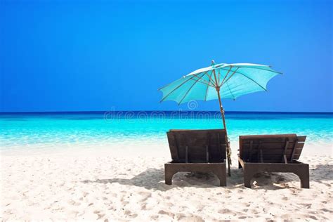 Beach chairs with umbrella stock photo. Image of sand - 32599694