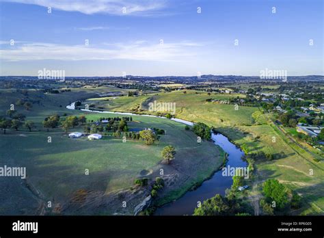 Yass River flowing through beautiful countryside at sunset - aerial view. Yass, NSW, Australia ...