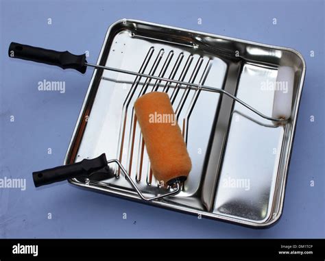 A decorators metal paint tray and rollers Stock Photo - Alamy