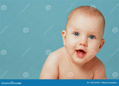 Close-up Portrait Of Adorable Newborn Baby Smiling On Isolated Blue Background. People Lifestyle ...