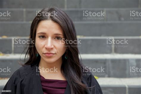 Young Woman Sitting On An Outdoor Stair Well Facial Expression Stock Photo - Download Image Now ...