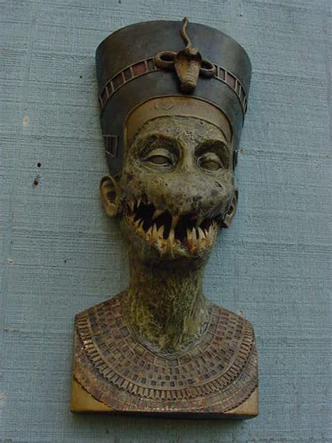 an ancient mask is mounted on the side of a building with it's mouth open