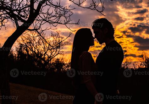 Silhouette of romantic couple in love, man and women in sunset sky. Romantic of relationships ...