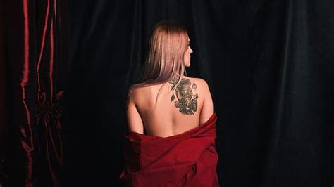 Royalty-Free photo: Person with tattooed skin wearing black denim bottoms | PickPik