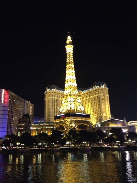 the eiffel tower is lit up at night in las vegas, nv