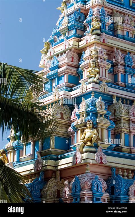 Indian gopuram temple architecture against a bright blue sky, in the ...