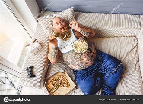 Fat guy eating junk food with enjoyment Stock Photo by ©iakovenko123 ...