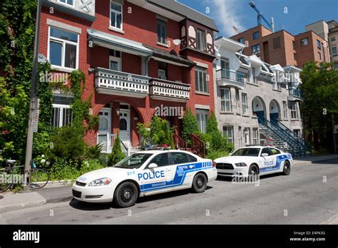 Two Montreal police patrol cars parked on a residential street Stock Photo - Alamy