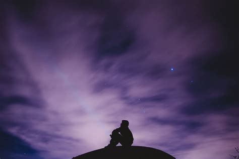 HD wallpaper: person sitting on black surface looking to sky ...