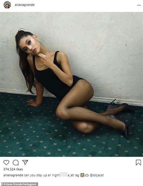 Ariana Grande stretches out in a slinky black dress and fishnets ...