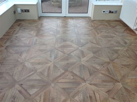 Parquet wood effect porcelain floor tiles give a fabulous finish to this conservatory. With ...