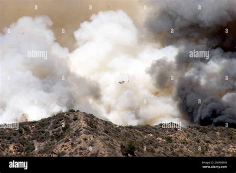 The famous Hollywood sign was in danger today as a fire raged on the ridge behind. Celebrity ...