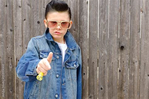 Elvis kid,Boy child dressed as 1950s style greaser ,rockabilly wearing denim jacket with ...