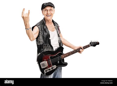 Studio shot of an old punk rocker holding a bass guitar and making a ...