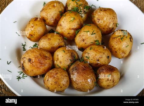 Baked potato with herbs and spices Stock Photo - Alamy