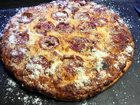 Pepperoni with a healthy sprinkle of parmesan cheese : Pizza