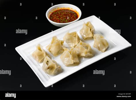 Fried dumplings with sauce Stock Photo - Alamy