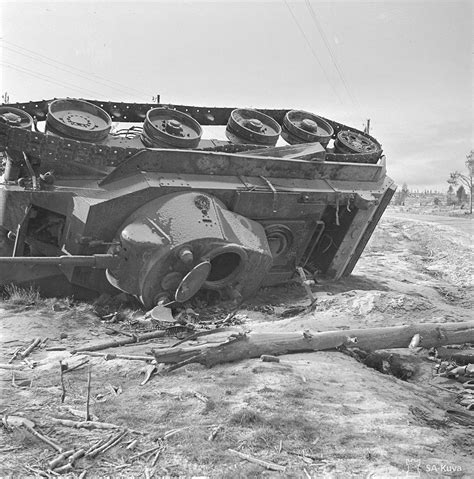 Continuation war destroyed tank in Salla. Wooden cross marks the grave of its driver. October ...