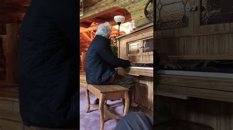 Tom Waits playing a piano on the set of The Ballad of Buster Scruggs in ...