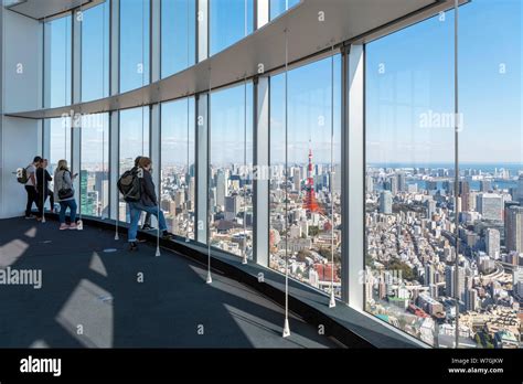 Visitors looking out over the city from the observation deck of the ...