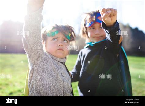 Two little boys dressed up as a superheros posing on a meadow Stock Photo - Alamy