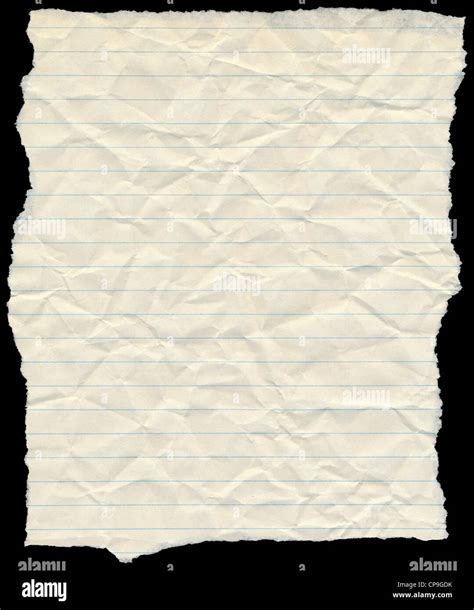 Old yellowing crumpled lined paper torn edges isolated on black Stock Photo - Alamy