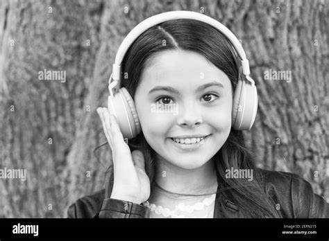 Hipster girl listening music modern headphones nature background, skip track concept Stock Photo ...