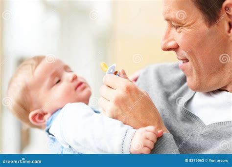 Stock Photos: Closeup of a young father carrying his baby. Image: 8379063