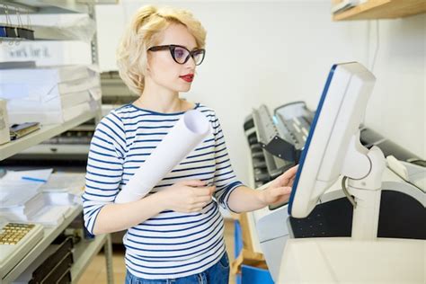 Premium Photo | Blonde woman operating printing press